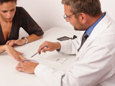 Doctor and patient going over papers in office