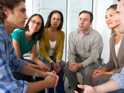 Support group meeting with diverse individuals